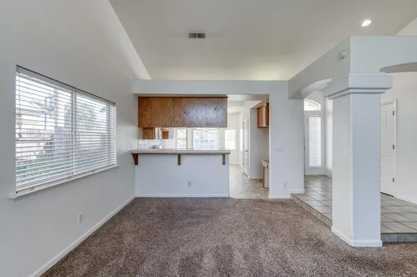 a view of a kitchen with a refrigerator and window