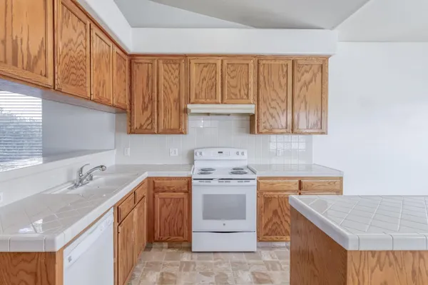 a kitchen with a sink cabinets and appliances
