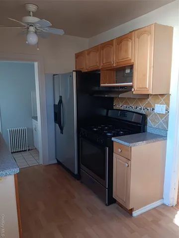 a kitchen with a refrigerator stove and microwave