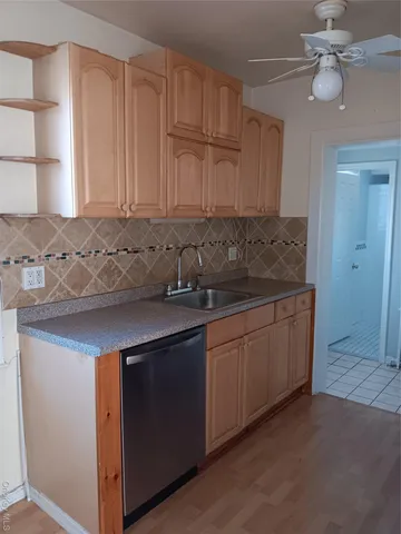 a kitchen with a sink cabinets and window