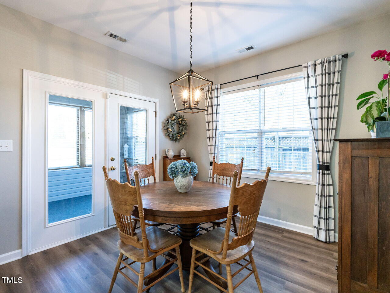 2740 Andover Glen Road Raleigh, NC 27604 - Photo 6 of 20 a dining room with furniture a chandelier and wooden floor