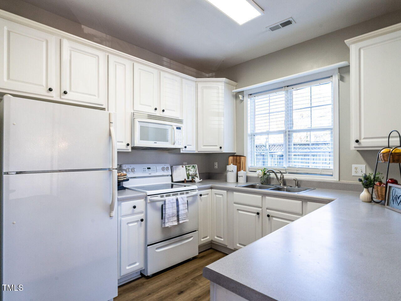 2740 Andover Glen Road Raleigh, NC 27604 - Photo 7 of 20 a kitchen with a sink a refrigerator and cabinets