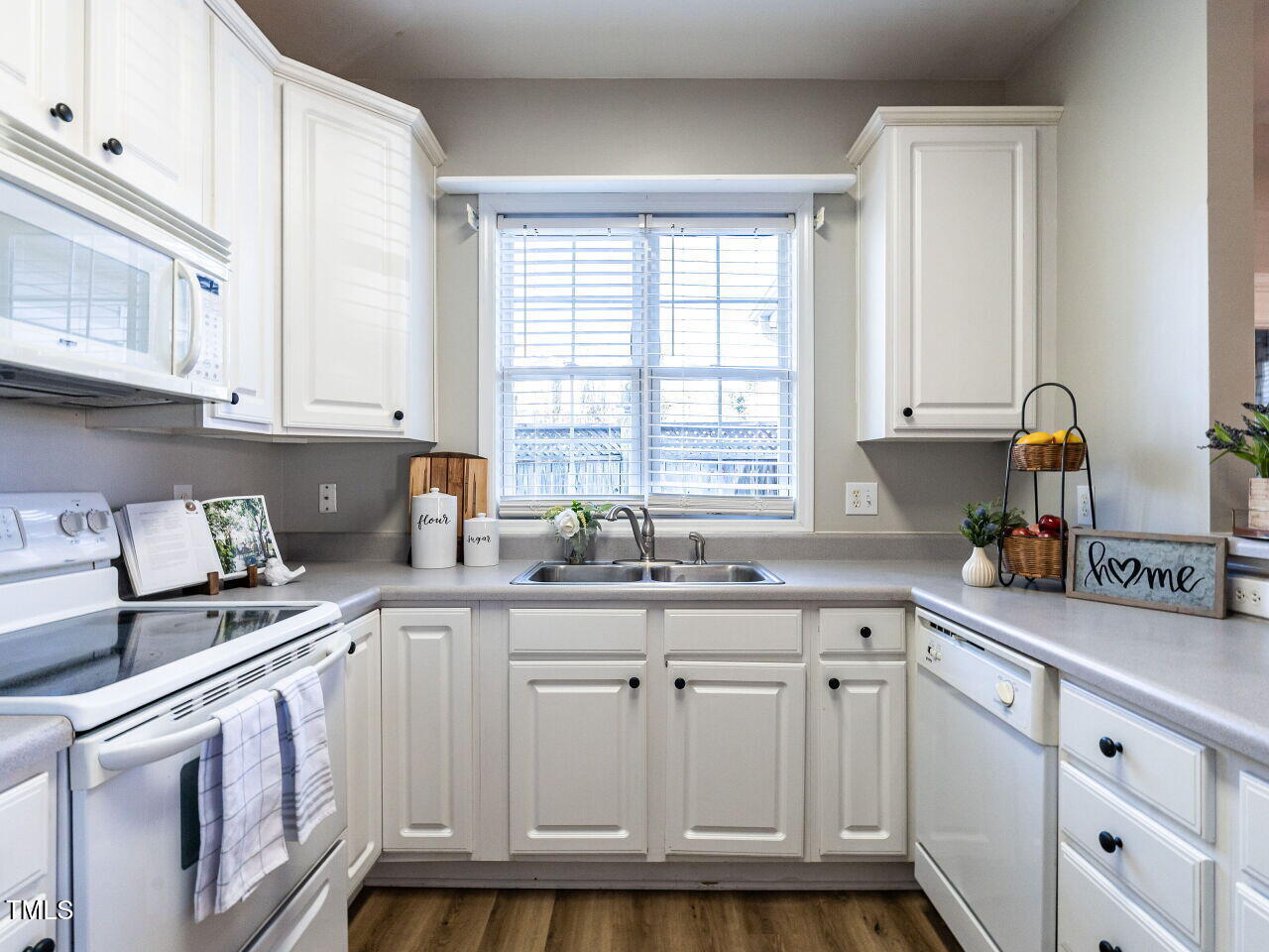 2740 Andover Glen Road Raleigh, NC 27604 - Photo 8 of 20 a kitchen with cabinets appliances a sink and a window
