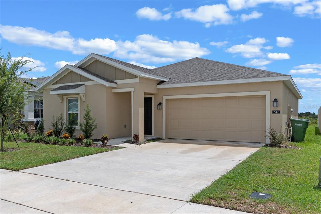 649 Reggie Road Lake Wales, FL 33859 - Photo 1 of 1 a front view of a house with a yard and garage