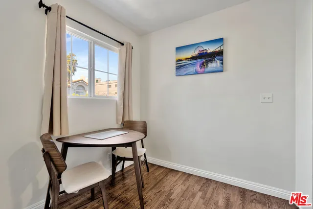 a view of a workspace with furniture and window