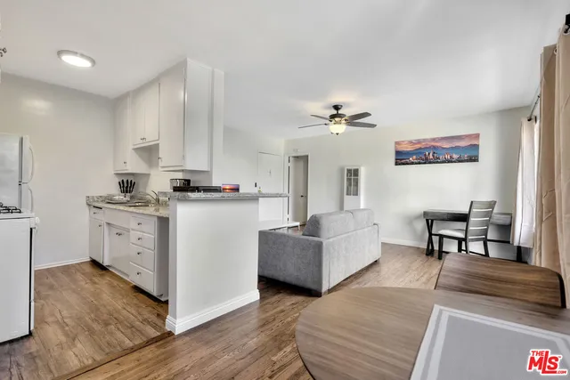 a view of kitchen with cabinets and window