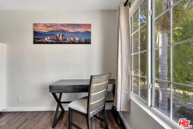 a view of a room with furniture wooden floor and window