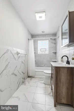 a bathroom with a bathtub and shower