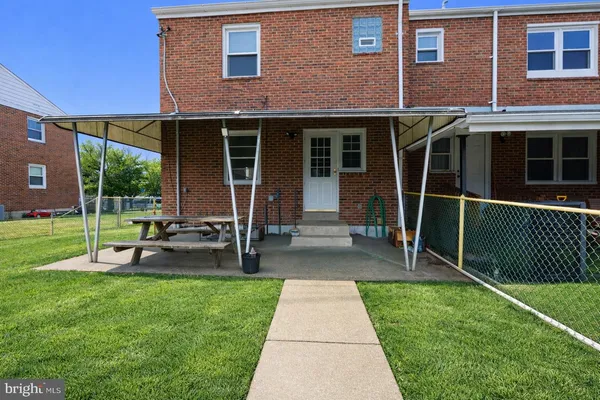 a view of a house with backyard porch and sitting area