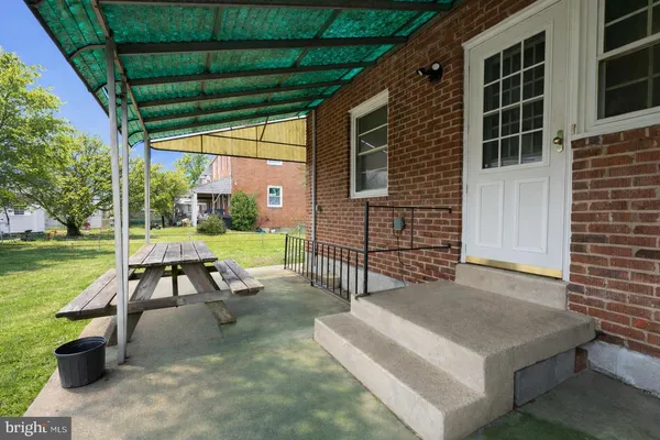 a view of a patio with a table chairs and a backyard