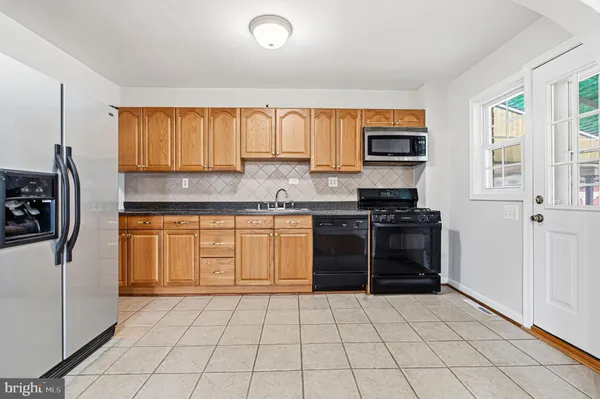a kitchen with a stove a sink and a refrigerator