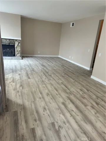 a view of an empty room with a fireplace