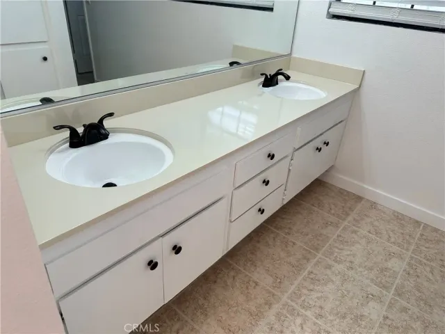 a bathroom with a double vanity sink and mirror