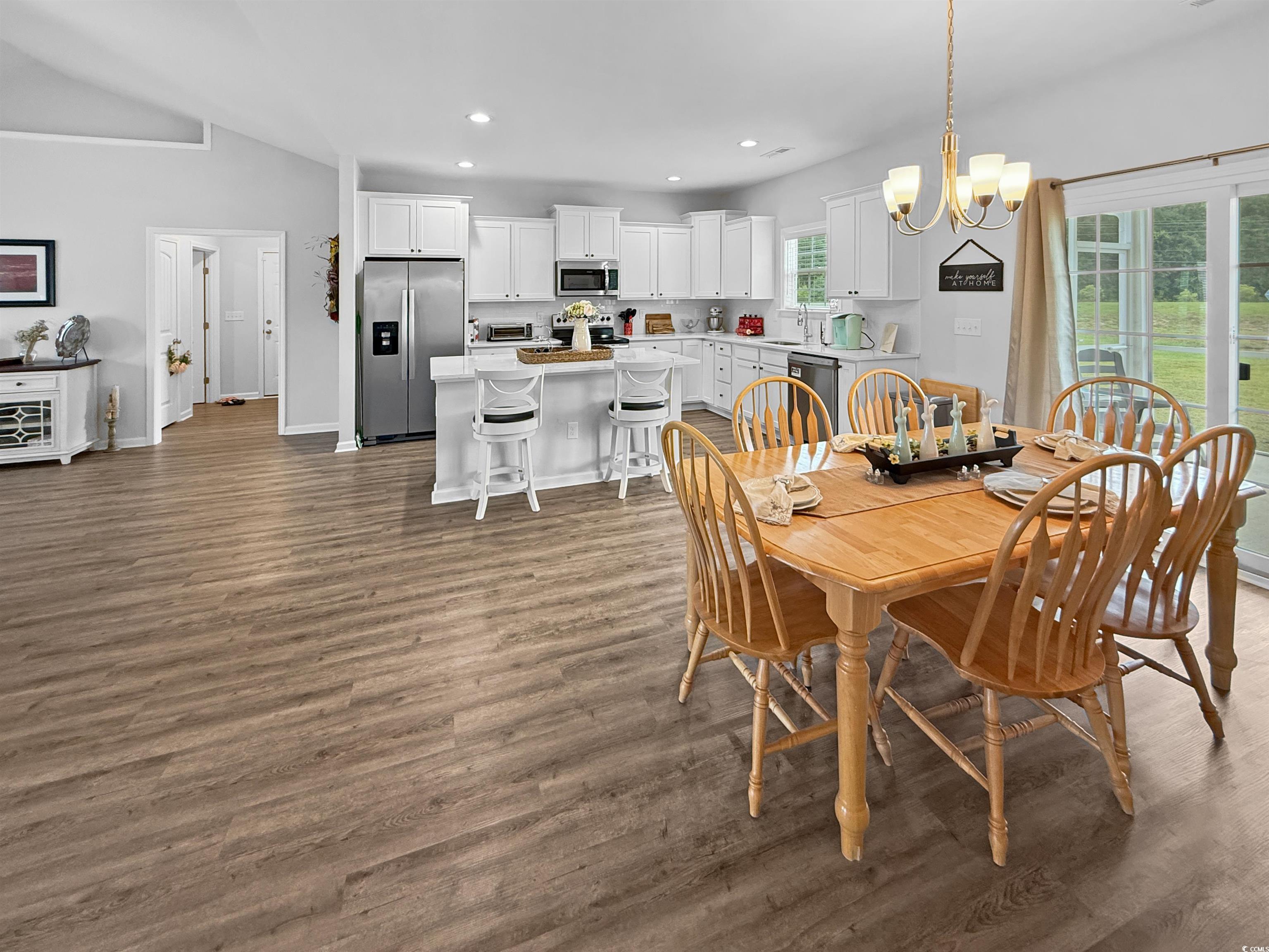 40 Little Peru Court Georgetown, SC 29440 - Photo 11 of 32 Dining space featuring dark wood-type flooring, recessed lighting, baseboards, a chandelier, and vaulted ceiling