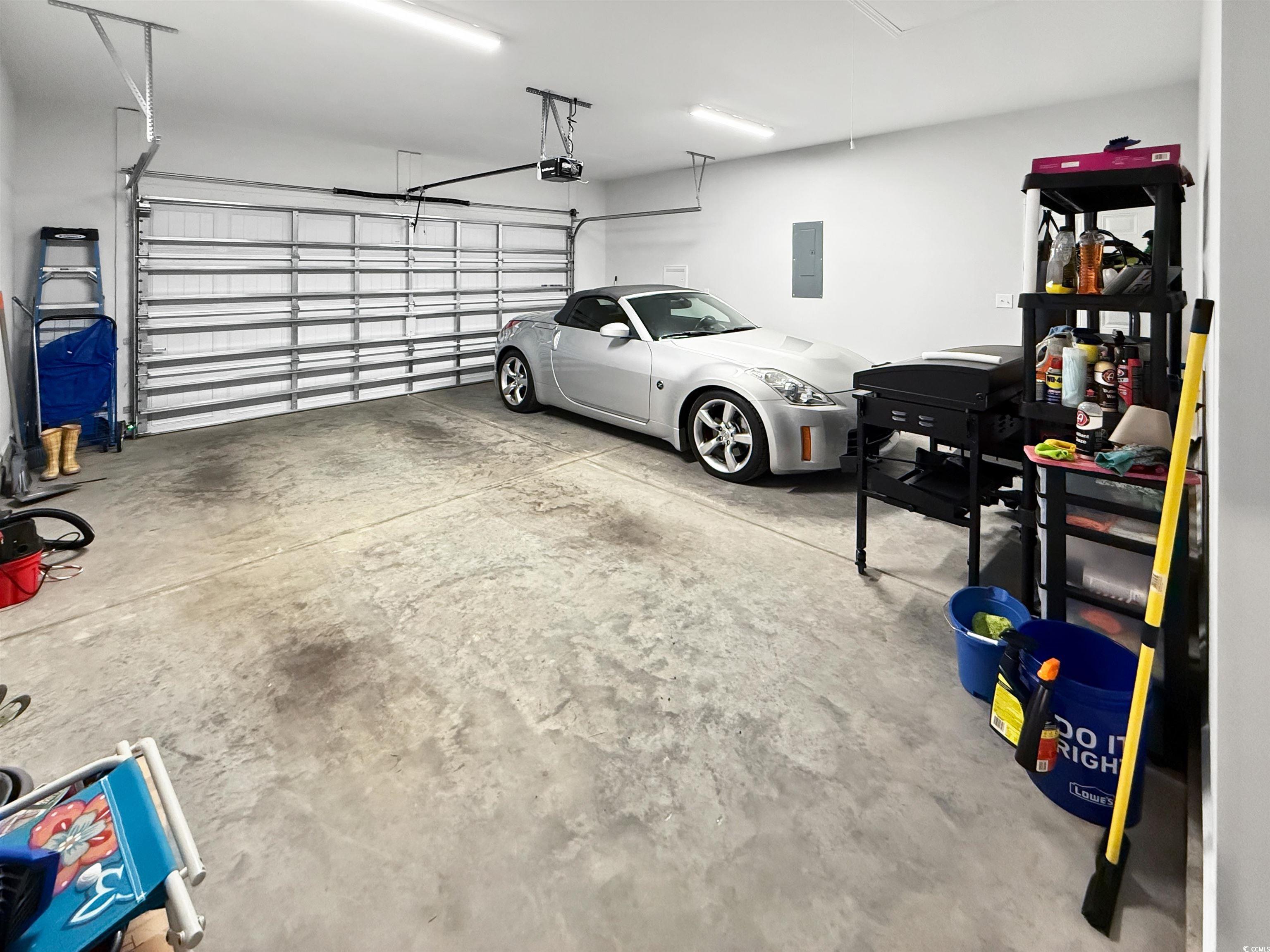 40 Little Peru Court Georgetown, SC 29440 - Photo 17 of 32 Garage with a garage door opener and electric panel