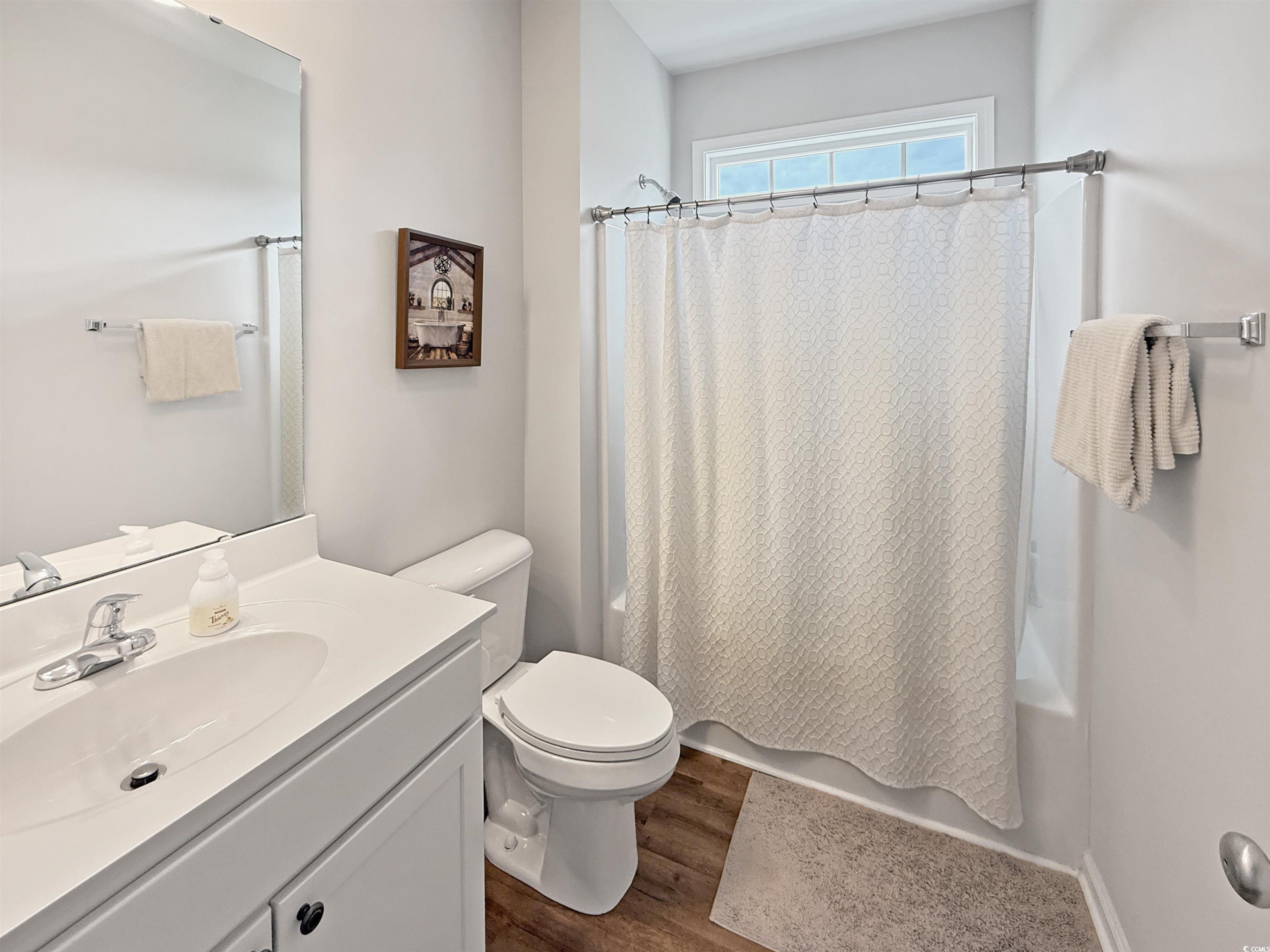 40 Little Peru Court Georgetown, SC 29440 - Photo 18 of 32 Bathroom with wood finished floors, shower / tub combo, toilet, and vanity