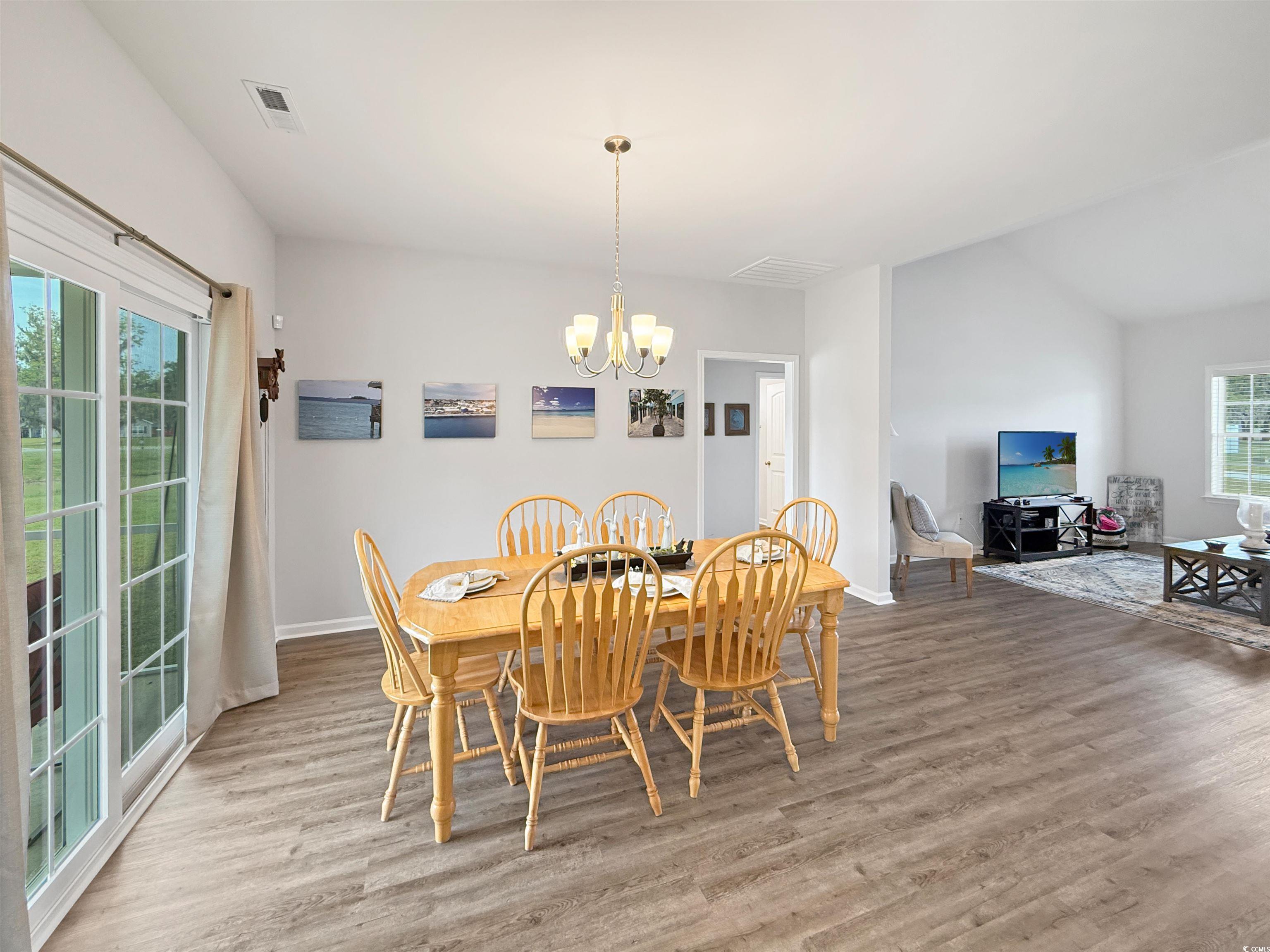 40 Little Peru Court Georgetown, SC 29440 - Photo 24 of 32 Dining area with a chandelier, wood finished floors, and baseboards