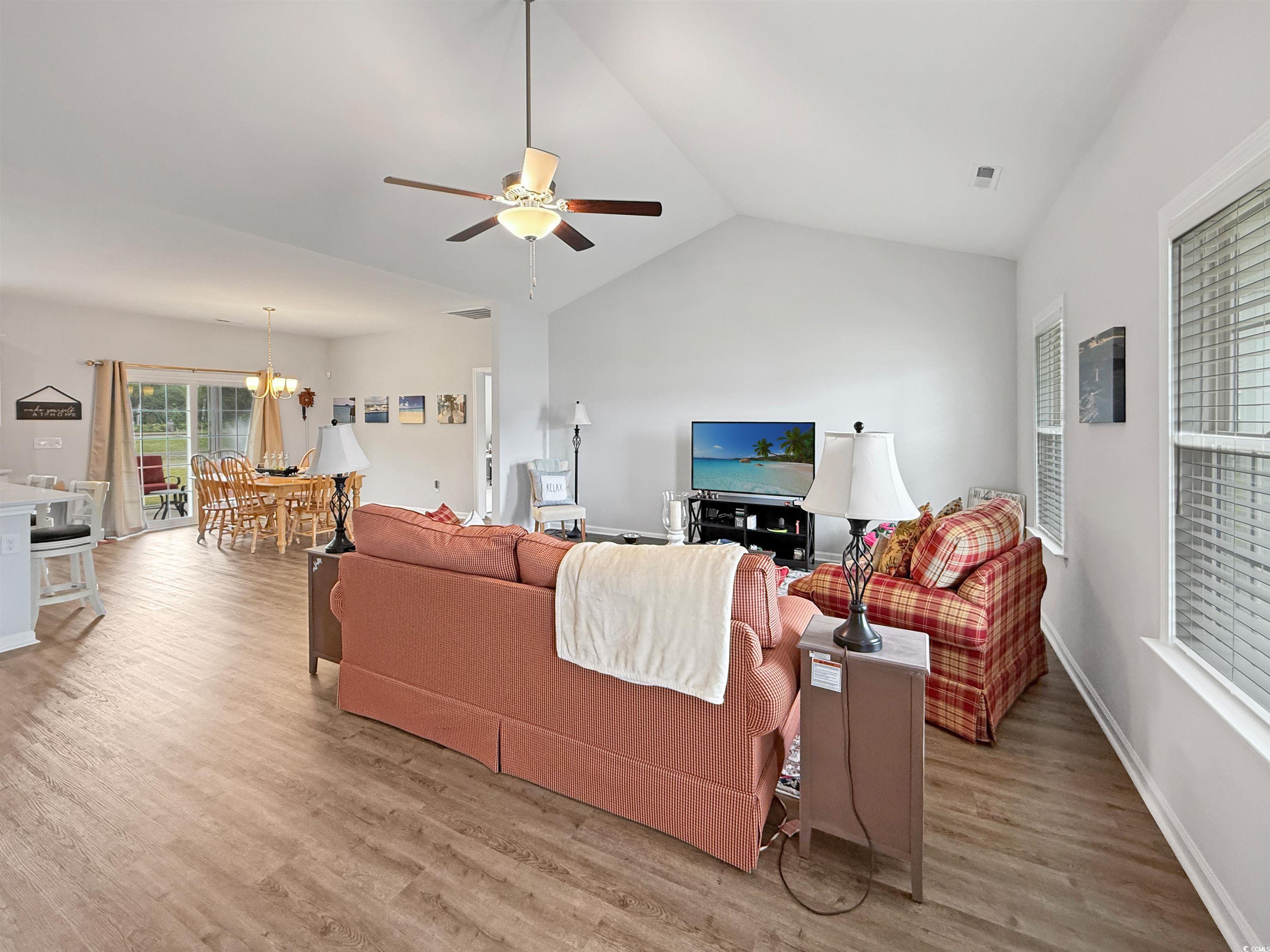 40 Little Peru Court Georgetown, SC 29440 - Photo 7 of 32 Living area featuring a chandelier, wood finished floors, ceiling fan, lofted ceiling, and baseboards