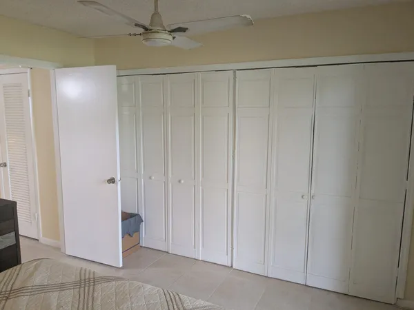 a view of a closet and chandelier fan in a room