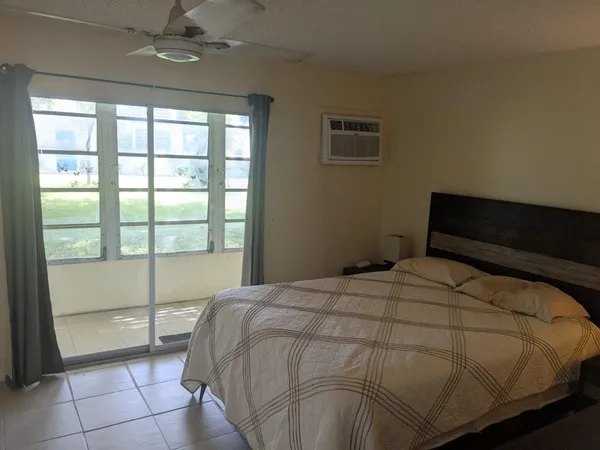 a bedroom with a bed and window