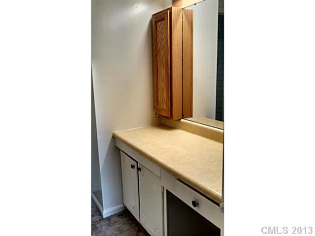 5817 F Hunting Ridge Lane Charlotte, NC 28212 - Photo 11 of 12 a bathroom with a granite countertop sink and a mirror