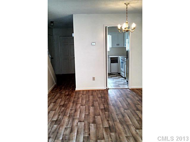 5817 F Hunting Ridge Lane Charlotte, NC 28212 - Photo 3 of 12 a view of a hallway with wooden floor and a dining table