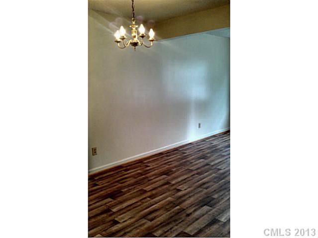 5817 F Hunting Ridge Lane Charlotte, NC 28212 - Photo 6 of 12 a view of a hallway with a chandelier