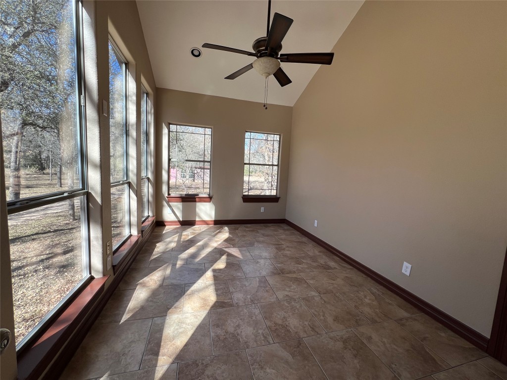 665 Wilson Road Red Rock, TX 78662 - Photo 26 of 34 Unfurnished sunroom featuring stone finish floors and high vaulted ceiling