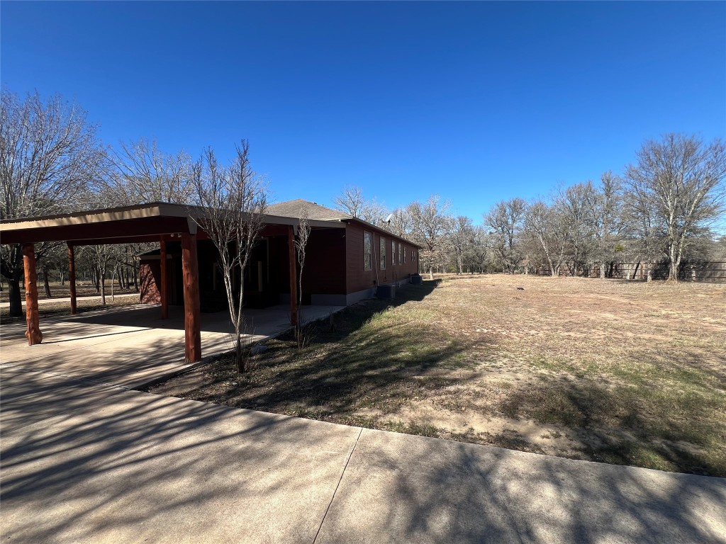 665 Wilson Road Red Rock, TX 78662 - Photo 4 of 34 View of property exterior with driveway and an attached carport