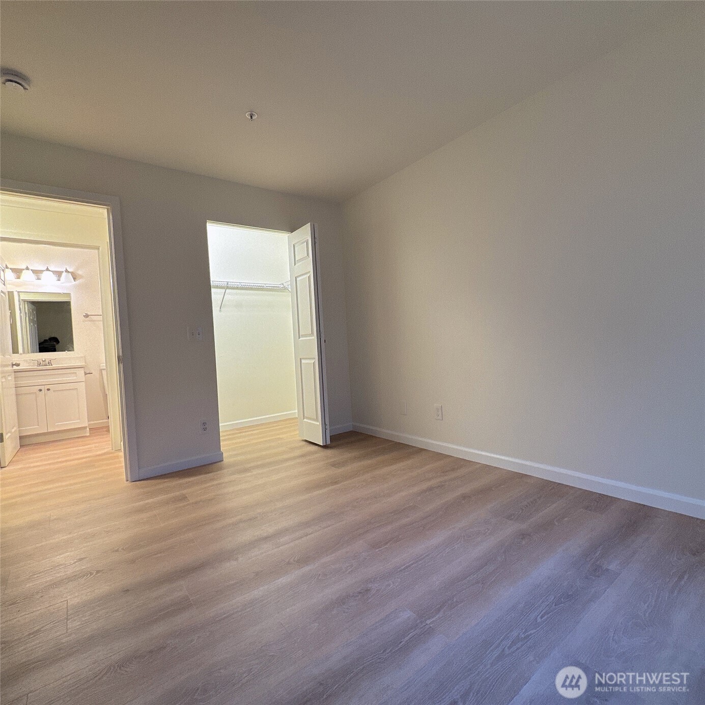 33020 10th Avenue Southwest, Unit A201 Federal Way, WA 98023 - Photo 12 of 15 a view of an empty room with wooden floor and a window