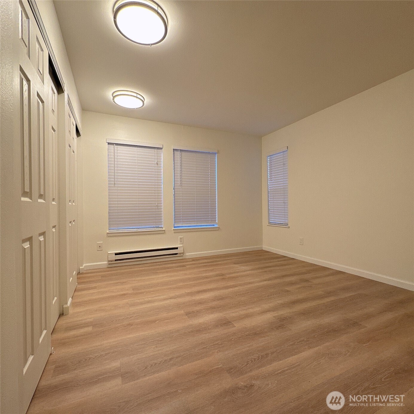 33020 10th Avenue Southwest, Unit A201 Federal Way, WA 98023 - Photo 14 of 15 a view of an empty room with wooden floor and a window