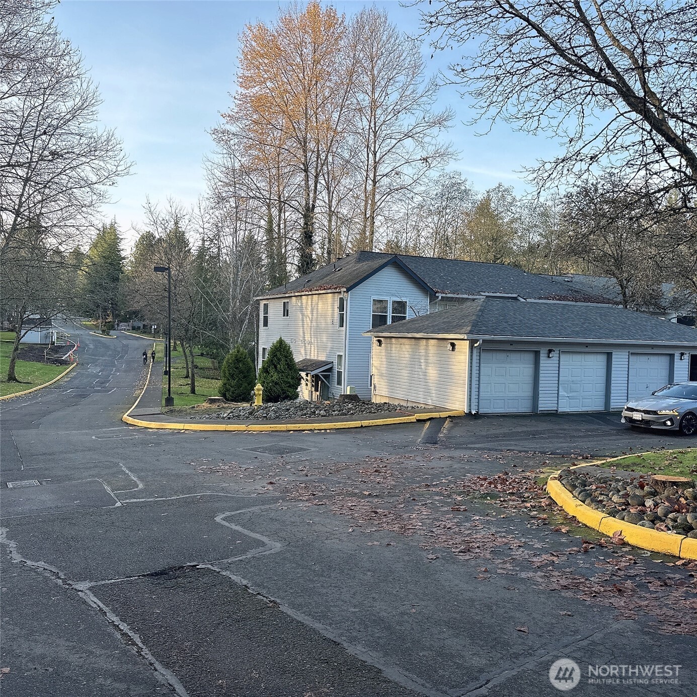 33020 10th Avenue Southwest, Unit A201 Federal Way, WA 98023 - Photo 2 of 15 a view of a house with a yard and large tree