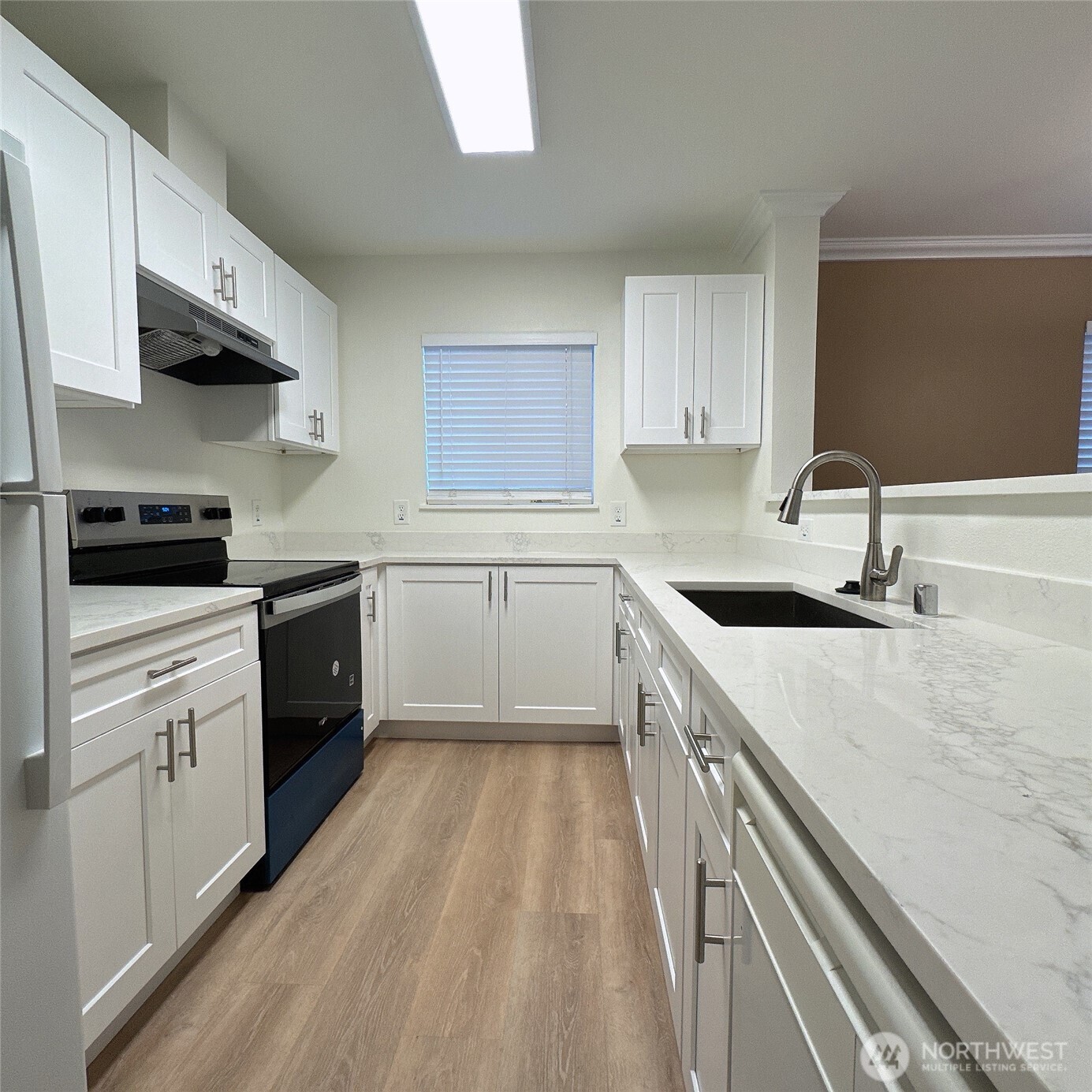 33020 10th Avenue Southwest, Unit A201 Federal Way, WA 98023 - Photo 4 of 15 a kitchen with a sink stove top oven and cabinets