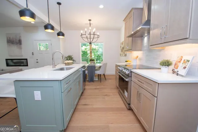 a large kitchen with a stove a sink a refrigerator and a counter space