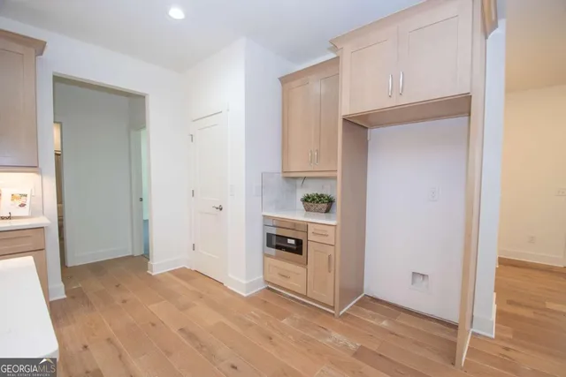 a view of a kitchen with wooden floor and a sink