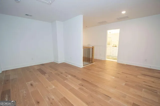 a view of a big room with wooden floor closet and windows