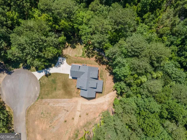 an aerial view of residential houses with outdoor space and swimming pool