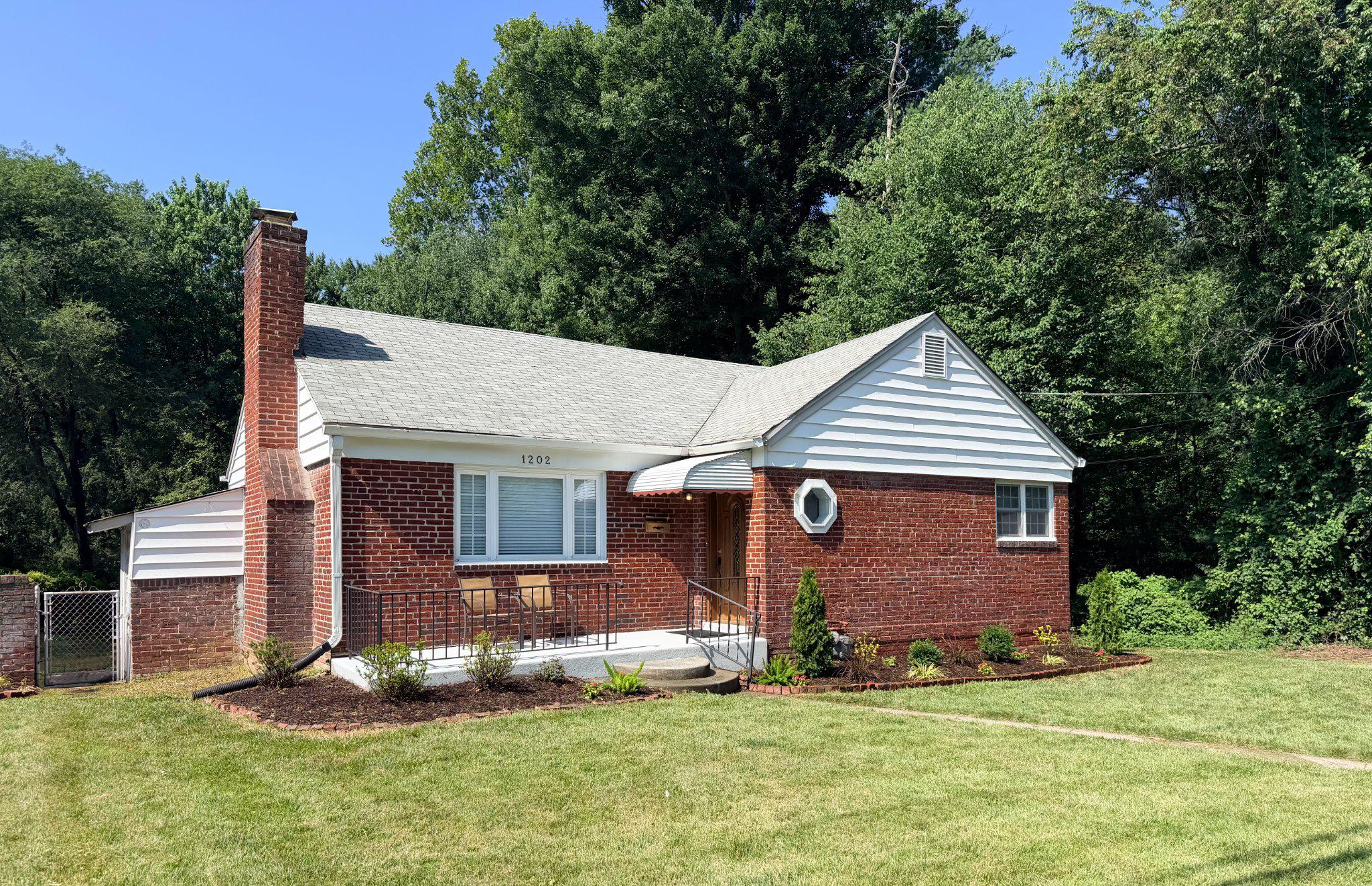 1202 Dennis Avenue Silver Spring, MD 20901 - Photo 2 of 2 Charming brick home in lush greenery.
