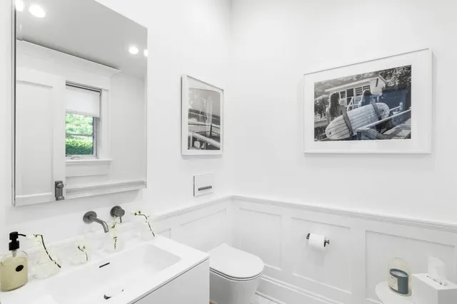 a bathroom with a sink a toilet and a window