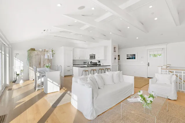 a view of a living room kitchen and a large window