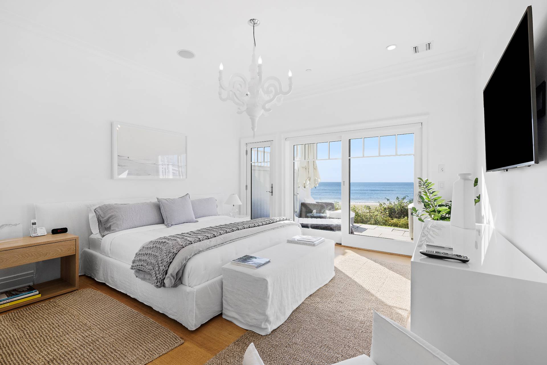 272 Old Montauk Highway Montauk, NY 11954 - Photo 9 of 25 a spacious bedroom with a bed and a flat screen tv