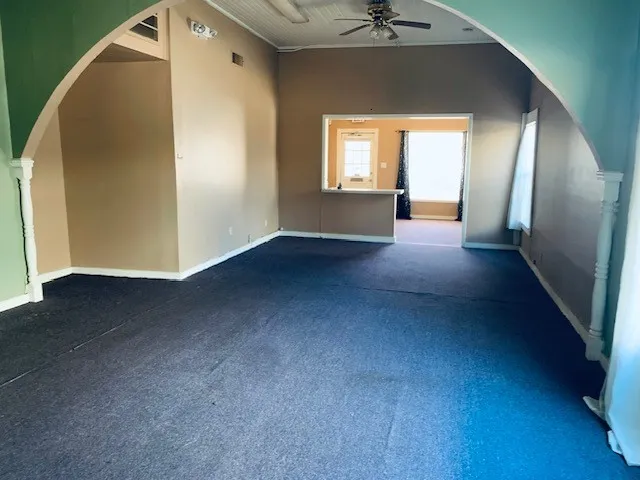 an empty room with a window and wooden floor