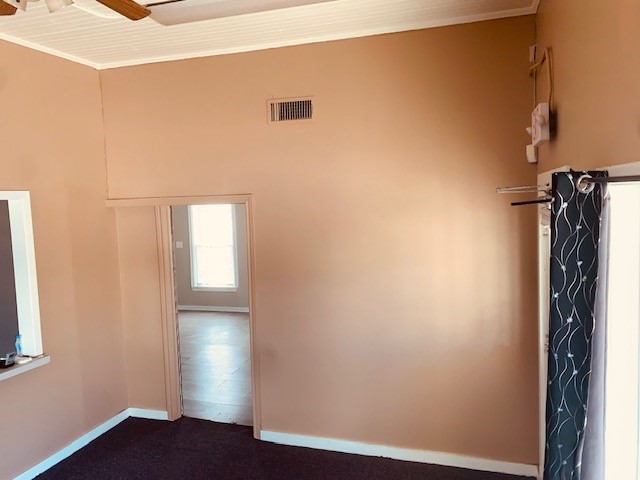 401 East Main Street Humble, TX 77338 - Photo 21 of 36 a view of empty room with wooden floor and fan