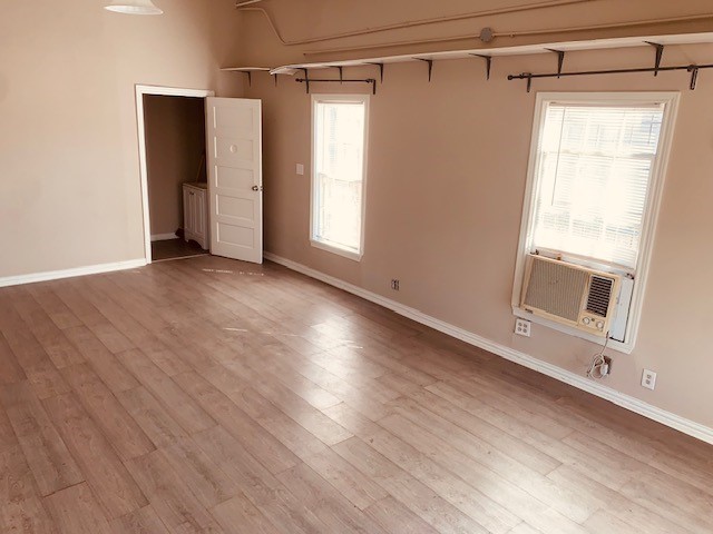 401 East Main Street Humble, TX 77338 - Photo 23 of 36 a view of an empty room with wooden floor and a window