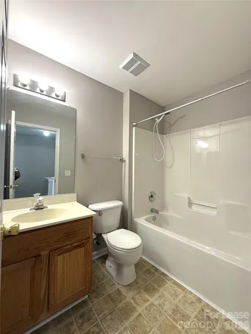 a bathroom with a double vanity sink toilet mirror and bathtub