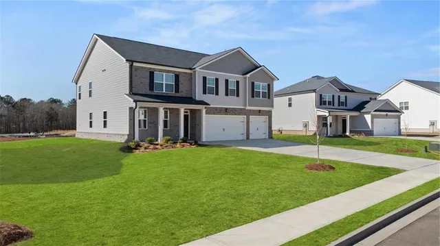 a front view of house with yard and green space