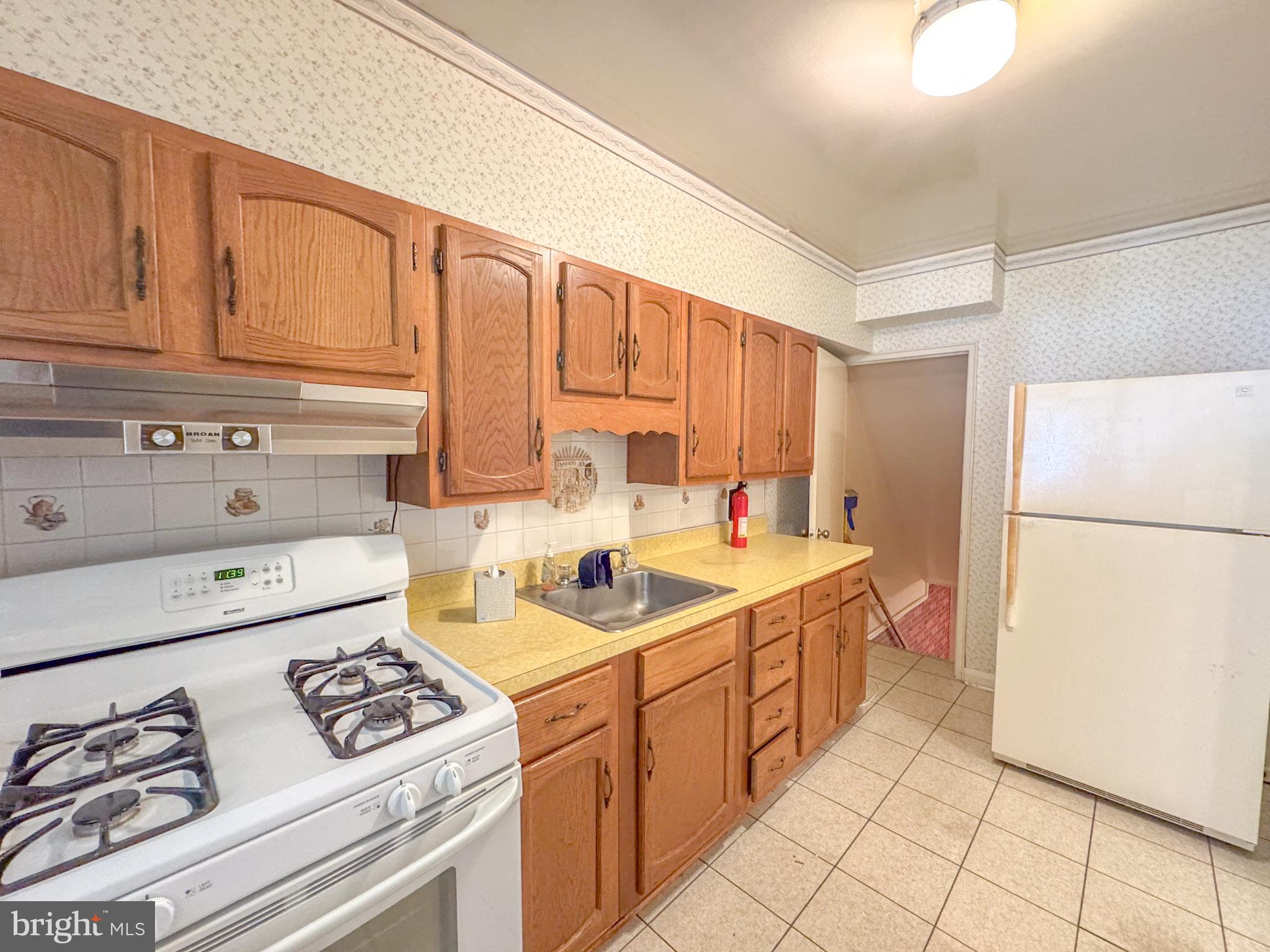 1948 Wareham Road Baltimore, MD 21222 - Photo 12 of 26 a kitchen with stainless steel appliances granite countertop a sink stove and refrigerator