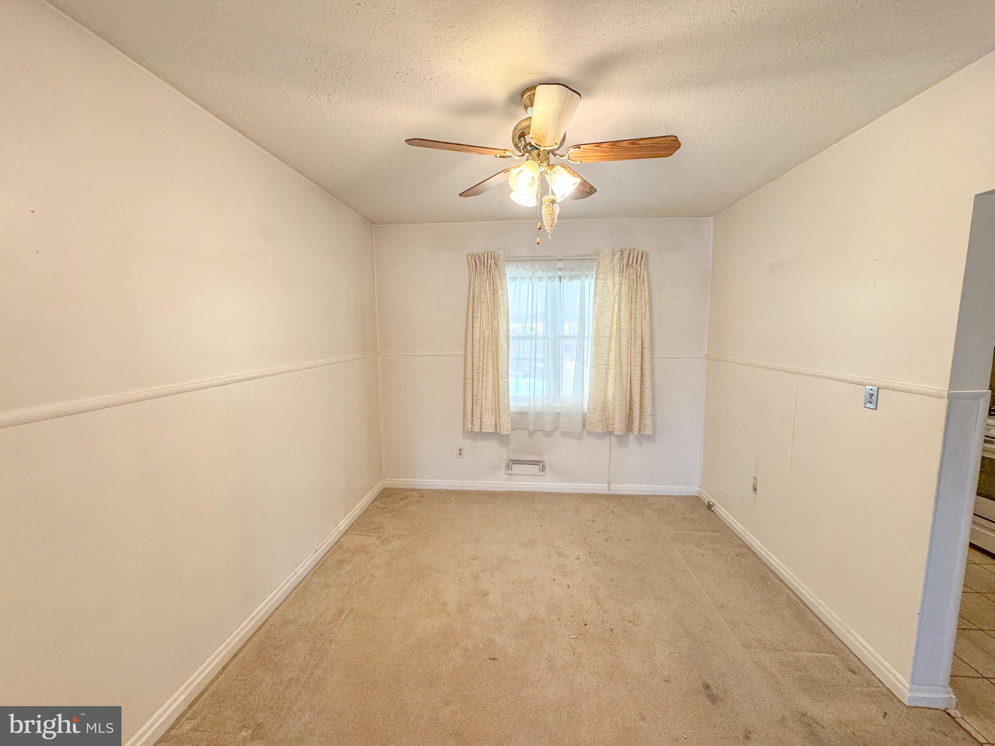 1948 Wareham Road Baltimore, MD 21222 - Photo 8 of 26 an empty room with windows and fan