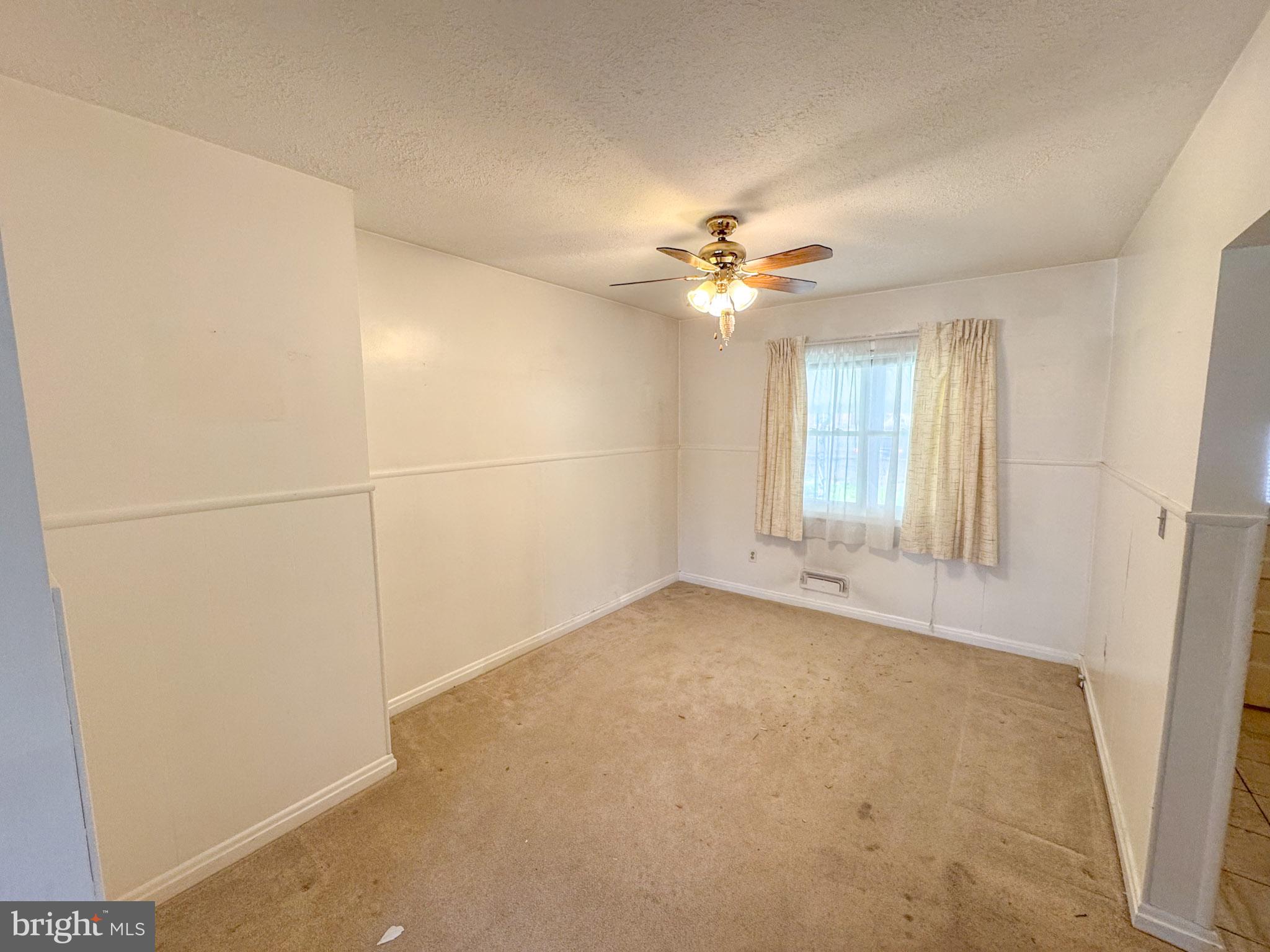 1948 Wareham Road Baltimore, MD 21222 - Photo 9 of 26 an empty room with windows and fan