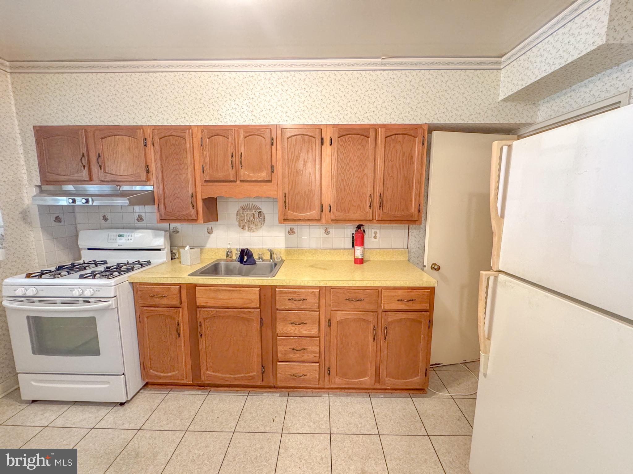 1948 Wareham Road Baltimore, MD 21222 - Photo 10 of 26 a kitchen with a stove top oven and cabinets